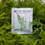 Woodie's select Root Booster: the best in plant nutrition. For time of planting or whenever transplanting. Pictured with vibrant evergreen foliage of american pillar arborvitae