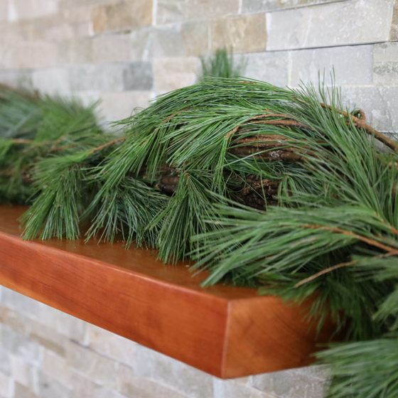 Fresh White Pine Garland Outlining a Fireplace