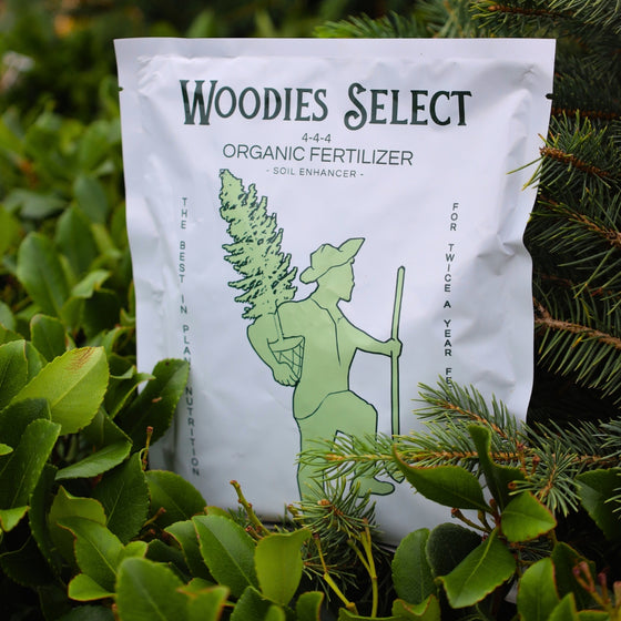 Woodie's Select Organic Fertilizer for landscape plants in a vibrant flourishing flower garden