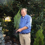 woodie pictured smiling with our 1-2 ft leyland cypress in a nursery pot