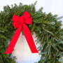 close up view of fraser fir wreath with vibrant red bow