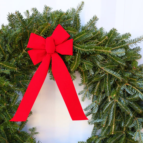 close up view of fraser fir wreath with vibrant red bow