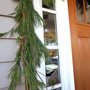 Fresh White Pine Garland Decorating a Door