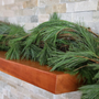 Fresh White Pine Garland Outlining a Fireplace