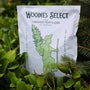 Woodie's Select Organic Fertilizer for landscape plants in a vibrant flourishing flower garden